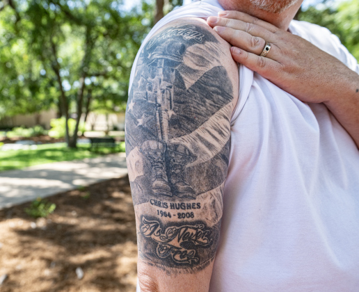 Army veteran Pat Nash shows his tattoo commemorating the life and service of his friend, Chris Hughes, who was killed in Afghanistan in 2008.  This was outside in the Williamson County Veterans Memorial Plaza  following  the Memorial Day ceremony held indoors  in Sun City on Monday, May 25, 2026.      Photo by Andy Sharp.