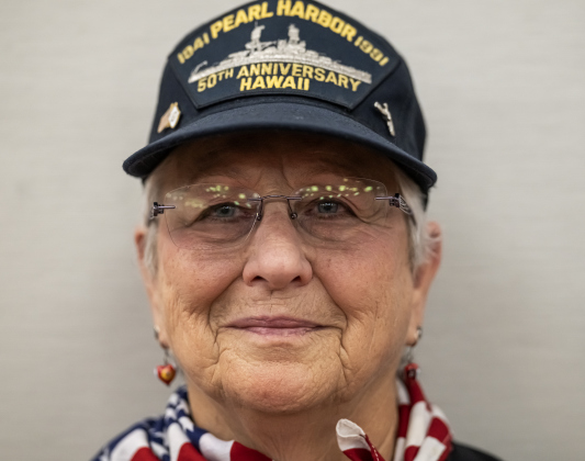 Shirley Harnes, a Coast Guard veteran who served from 1976-1995, wore the cap of her father, a Pearl Harbor survivor, during the Memorial Day ceremony held in Sun City on Monday, May 25, 2026.   Photo by Andy Sharp.