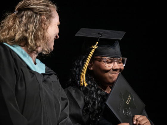 Richarte graduate Kalynn Keyauna Vance-Warner, right, with Richarte counselor Christina Hollander, left, smiles after receiving her diploma during the Richarte High Class of 2026 Commencement held at the Rodney and Mary Klett Performing Art Center on Thursday, May 21, 2026.