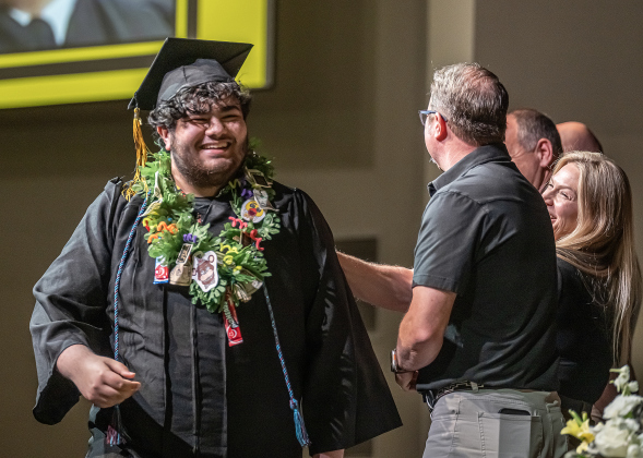 Richarte graduate Carson Adams Mansoor smiles as he receives his diploma during the Richarte High Class of 2026 Commencement held at the Rodney and Mary Klett Performing Art Center on Thursday, May 21, 2026.