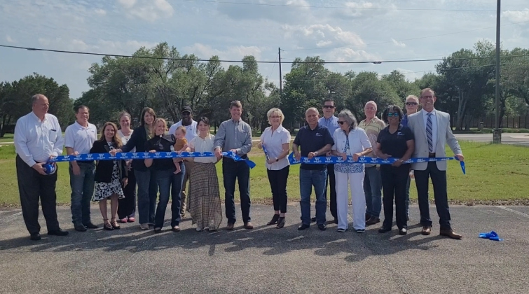 Williamson County marked the completion of the Sam Bass Road/Corridor H project with a ribbon cutting ceremony on Friday, April 24. County Commissioner Valerie Covey cuts the ribbon. Photo by Nalani Nuylan.