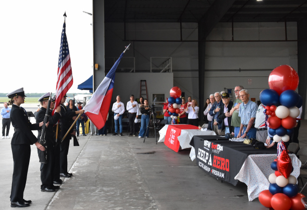 The East View High School Color Guard opened the day with a presentation of the colors. The veterans and their guests are seen at right.