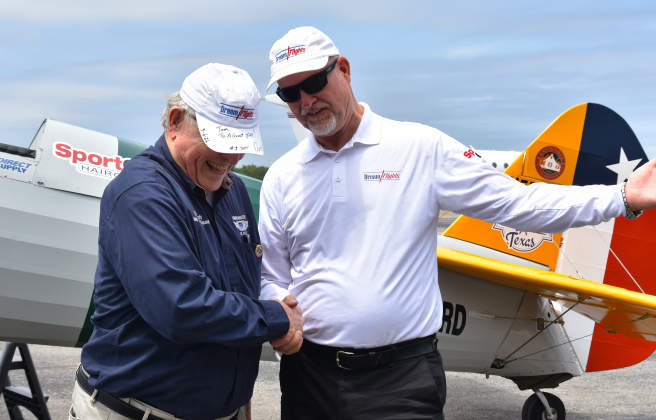 Tom Gordy, left, shakes the hand of pilot and founder of Dream Flights Darryl Fisher after being the first person to fly on the Spirit of Texas plane on May 6.