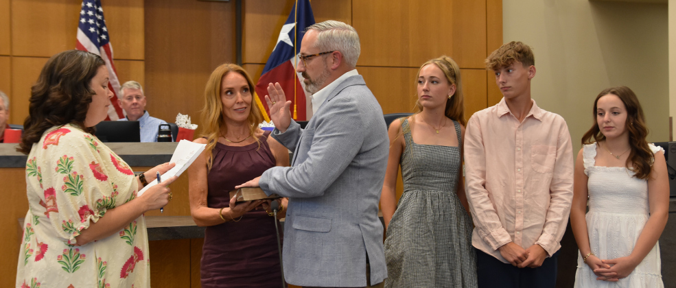 Doug Noble, who took over for Shawn Hood for District 2, is sworn in with his wife Kasie and his children during his swearing in on May 12. 