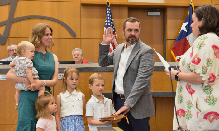 District 6 Council Member Jake French was re-sworn into his position after winning the city council election on May 2. He was joined by his four children and wife Allison.