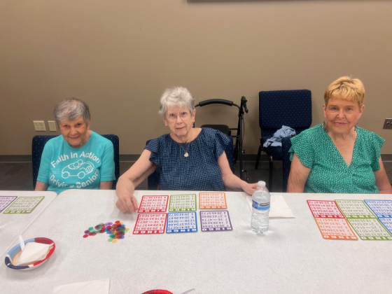  Carol Pierroforte (left) plays BINGO with other seniors at a Faith in Action event. Last month, a Faith in Action driver saved Ms. Pierroforte in a medical emergency.