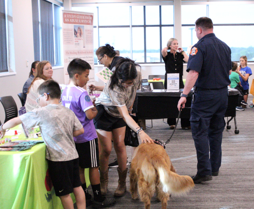 Koda, the Georgetown Fire Department’s Therapy dog, says hi to attendees and vendors at the Mental Health and Wellness Expo. Photo by Nalani Nuylan.