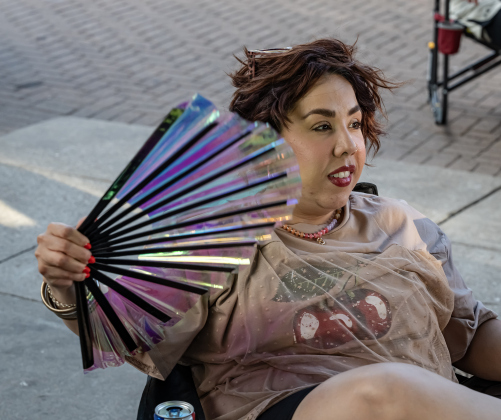 Selenne Perea cools off with her fan while enjoying  to the music played by  Vinyl Countdown G/ATX! during the free First Friday concert held on the Williamson County Courthouse lawn on Friday, June 12, 2026.  The concerts, hosted by the Georgetown Beard Club, are generally on the first Friday of the month, but this one was postponed because of rain last week.     Photo by Andy Sharp