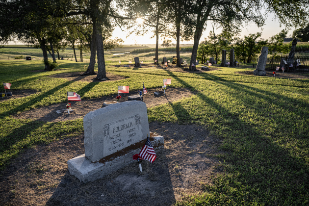 American flags adorn burial sites at Mager Cemetery on Saturday, June 13, 2026.  They were placed this weekend by volunteers from the Hermann Sons Coupland-New Bern Lodge.  The flags coincide  with Flag Day on Sunday, June 14, 2026.   Photo by Andy Sharp