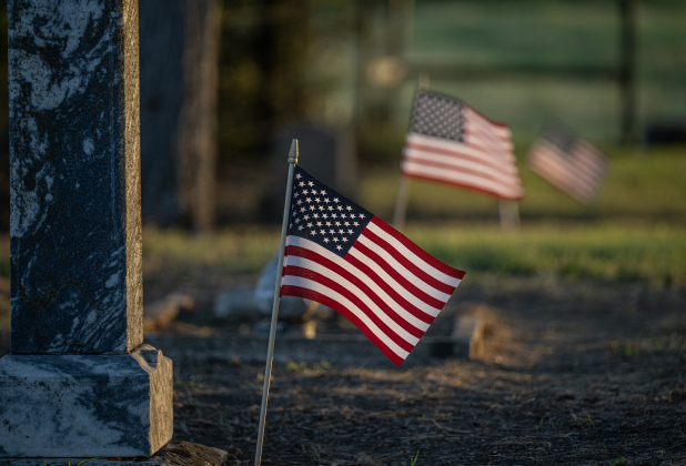 American flags adorn burial sites at Mager Cemetery on Saturday, June 13, 2026.  They were placed this weekend by volunteers from the Hermann Sons Coupland-New Bern Lodge.  The flags coincide  with Flag Day on Sunday, June 14, 2026.   Photo by Andy Sharp