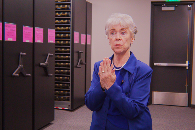 County Clerk Nancy Rister explains the collection of county documents in the research library at the new administration building. There are more than 700 books in the room. Photo by Nalani Nuylan.