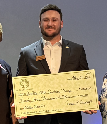 Austin Sunshine Camps Board Member Eric Hester accepts a received a $25,000 Seeds of Strength grant.