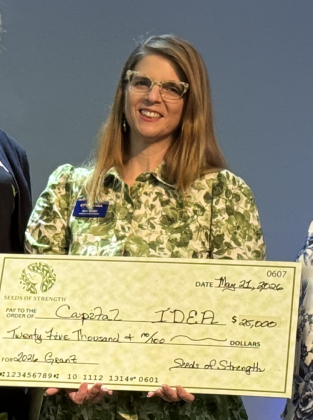 Capital IDEA Director of Development and Communications Amy Silvey accepts a $25,000 grant.