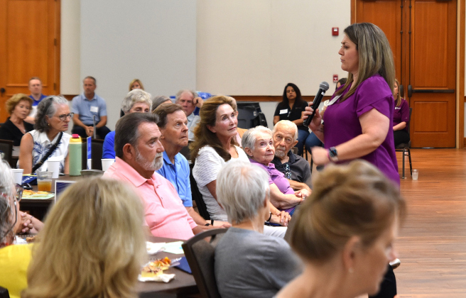 Anne Marshall, left, embraces her daughter, Valerie Schultz, during the Fraud Awareness Breakfast. A victim of an online scam earlier this year, Ms. Marshall was the guest of honor for the event, which served as a fundraiser.  Photo by Nicholas Cicale