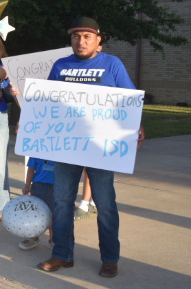 Proud Bartlett High School dad Jose Benitez greets his daughter, 11th grader Jessica, home from national competition. She was a member of the winning Knowledge Bowl team.