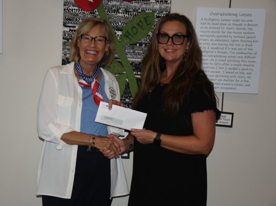 Judy Madsen, Women Helping Others vice president, meets with Sarah Bolton, executive director of Wilco Women’s Health Center, to make a donation.  Photo by Anne Marshall