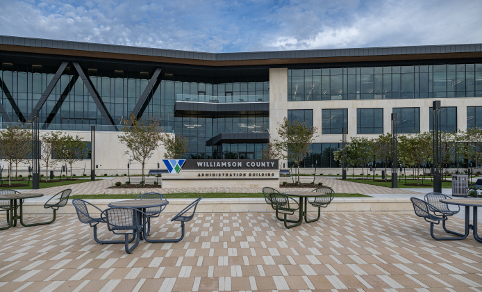 A central courtyard outside the new Williamson County Administration Building, with the county logo in the center.