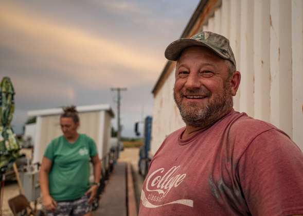 Farmer Steven Raesz, is pictured at the grain elevators where harvested corn is collected  during the corn harvest of  Steven and his brother Shaun  on Friday, July 10, 2026.  Helping out is Kate Kennedy, Steven’s longtime girlfriend, a teacher and volleyball coach at Granger ISD.  These East Williamson County farmers are harvesting over 4,000 acres of corn this year.    Photo by Andy Sharp