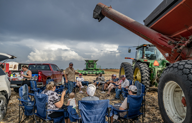 Workers take a supper break during the corn harvest of brothers Shaun and Steven Raesz  along County Road 414 on Friday, July 10, 2026.  Shaun Raesz, 51, is standing at center.  These East Williamson County farmers are harvesting over 4,000 acres of corn this year.    Photo by Andy Sharp