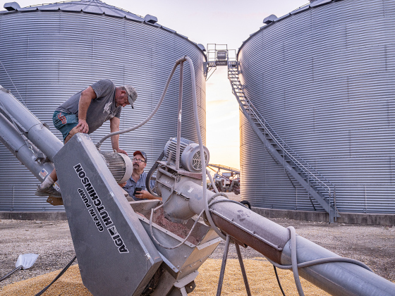 Steven Raesz, 49, left, and his brother Shaun, 51, make some adjustments to equipment by their grain elevators  during their  2026 corn harvest  on Saturday, July 11, 2026.  The family is harvesting over 4,000 acres of corn this season.     Photo by Andy Sharp
