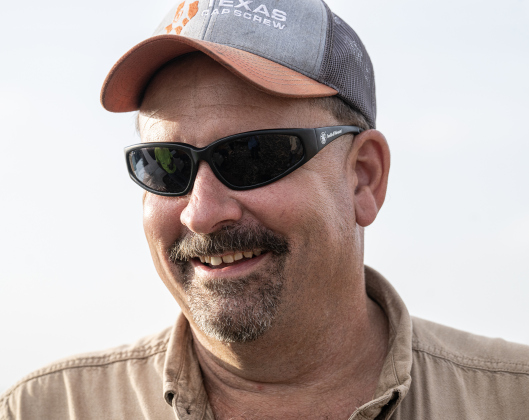 Farmer Shaun Raesz relaxes during a harvest supper break  along County Road 414 on Friday, July 10, 2026.  He and his brother Steven are harvesting  over 4,000 acres of corn this year.    Photo by Andy Sharp