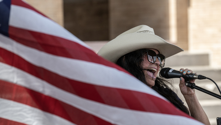 Singer Janie Balderas performs “The Star-Spangled Banner” along 7th Street during Market Days on Saturday, July 11, 2026.  Market Days  is held on the second Saturday  of the month in downtown Georgetown.   Photo by Andy Sharp