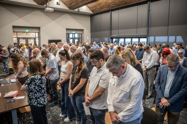 Attendees bow their heads for an invocation conducted by former County Judge Bill Gravell  during the Grand Opening Ceremony for the Williamson County Administration Building on Tuesday, July 14, 2026.  A County Showcase was held in addition to a ribbon cutting ceremony in the County Commissioners Courtroom.   Photo by Andy Sharp