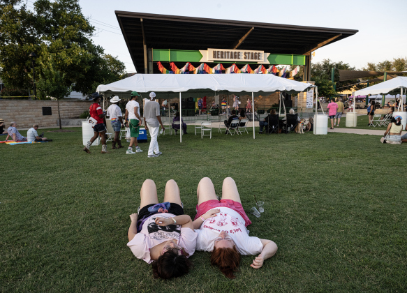 Raeann Rojas, left, and Megan Soetaert, who were recently married, enjoyed relaxing on the lawn during the 6th Annual Taylor Pride Festival, held at Heritage Square Park on Saturday evening, June 27, 2026.     Photo by Andy Sharp