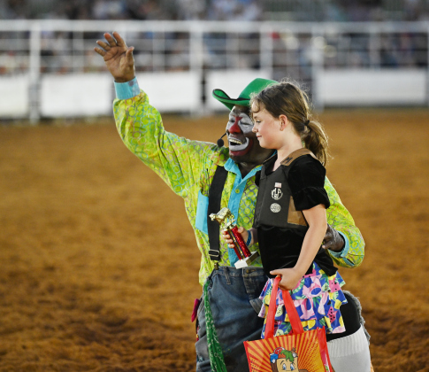 Rodeo clown Leon Coffee congratulates 6-year-old Maya Thurston after she won first place in Mutton Bustin’ at the 82nd Annual Williamson County Sheriff’s Posse Rodeo on Friday, June 26, 2026. The rodeo continued through Saturday night.    Photo by Andy Sharp