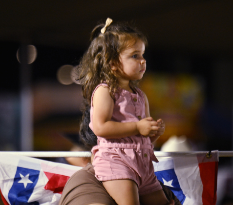 2-year-old Grace Castillo got a boost onto the shoulders of her mom Samantha Castillo so she could clearly see the arena action during the 82nd Annual Williamson County Sheriff’s Posse Rodeo on Friday, June 26, 2026. The rodeo continued through Saturday night.    Photo by Andy Sharp