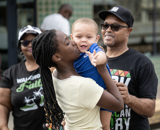 12-year-old Kambrie Coulter cuddles with her cousin Kaison Chandler, 1, as they spend time with their grandparents Earnest and Wendy Banks during Taylor’s Juneteenth celebration on Saturday, June 20, 2026.   Their family was watching the parade along Main Street.   Photo by Andy Sharp
