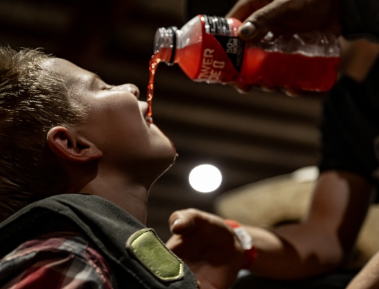 RJ Jackson, 13, from Kaufman, Texas, gets a drink of Powerade from his dad Richard Jackson before competing in bull riding  during the 3rd Annual Bill Pickett Youth Rodeo, held at the Williamson County Expo Center on Saturday, June 20, 2026.  Contestants can be no older than 18 to participate.     Photo by Andy Sharp