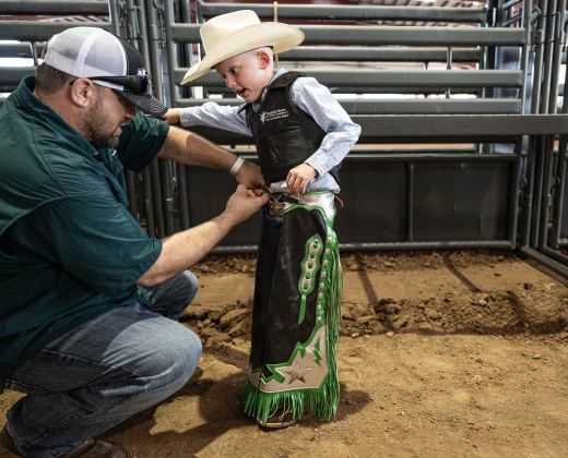 6-year-old calf rider Anderson Traynham gets assistance from his father Chris Traynham before  competing  during the 3rd Annual Bill Pickett Youth Rodeo, held at the Williamson County Expo Center on Saturday, June 20, 2026.  Contestants can be no older than 18 to participate.     Photo by Andy Sharp