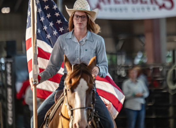 Heather Hines rides through the arena with the American flag at the start of the 3rd Annual Bill Pickett Youth Rodeo, held at the Williamson County Expo Center on Saturday, June 20, 2026.  Contestants can be no older than 18 to participate.     Photo by Andy Sharp