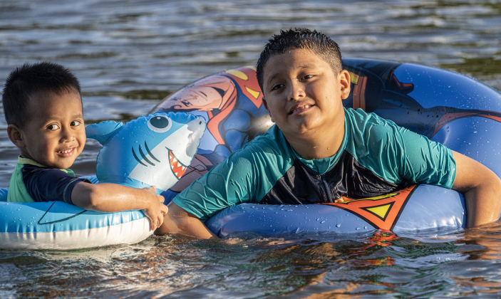 3-year-old Fran Rodriguez, left, and his brother Hank, 9, enjoyed the cool waters of the San Gabriel River near San Gabriel Park on Monday, June 22, 2026, the first day of summer.  Temperatures reached into the mid-upper 90s on this day.    Photo by Andy Sharp