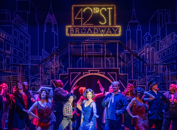 Antonette Knoedl, center (in blue dress), as Peggy Sawyer, is shown in a photo from the dress rehearsal of the Georgetown Palace production of “42nd Street”  on Thursday, July 23, 2026. The show runs through August 30 on the Springer Stage.   Photo by Andy Sharp