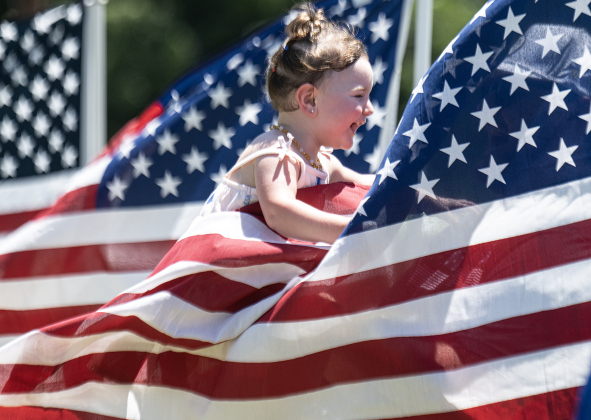 18-month-old Addison Gonzalez enjoyed being among the American flags displayed by the Rotary Club of Georgetown during the Sertoma Club 4th of July celebration at San Gabriel Park  on Saturday, July 4, 2026.   Photo by Andy Sharp