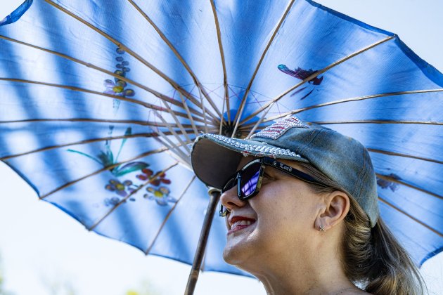 Jennifer Van Pelt made good use of a parasol to fend off the heat  during the Sertoma Club 4th of July celebration at San Gabriel Park  on Saturday, July 4, 2026.   Photo by Andy Sharp
