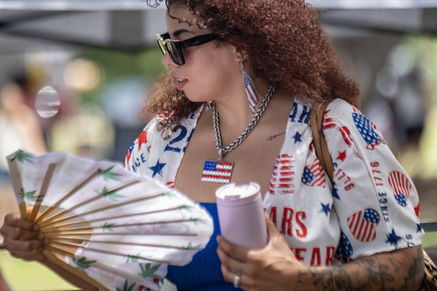 Leah Ibarra uses a fold-out fan to help with the afternoon heat during the Sertoma Club 4th of July celebration in San Gabriel Park  on Saturday, July 4, 2026.   Photo by Andy Sharp