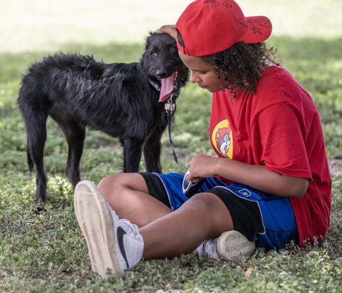 12-year-old Taylor Sullen and her dog Oakley find a shady tree to ward off the afternoon heat during the Sertoma Club 4th of July celebration at San Gabriel Park on Saturday, July 4, 2026.  Taylor’s mom soon brought a cold bottle of water for Oakley.   Photo by Andy Sharp