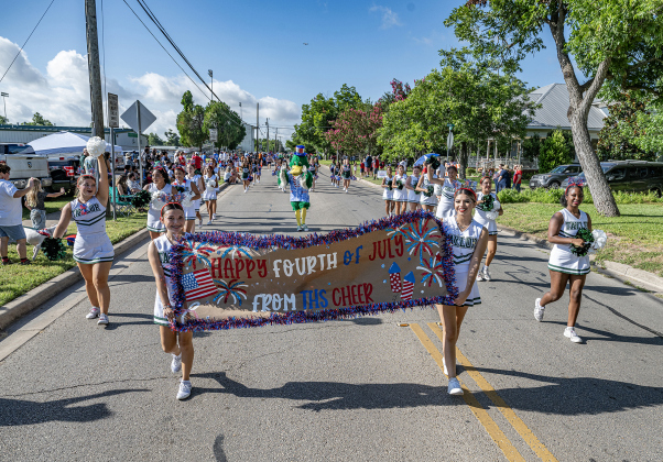 Members of the Taylor High cheerleading squad march along Davis Street during Taylor’s  4th of July parade on Saturday, July 4, 2026.   Photo by Andy Sharp