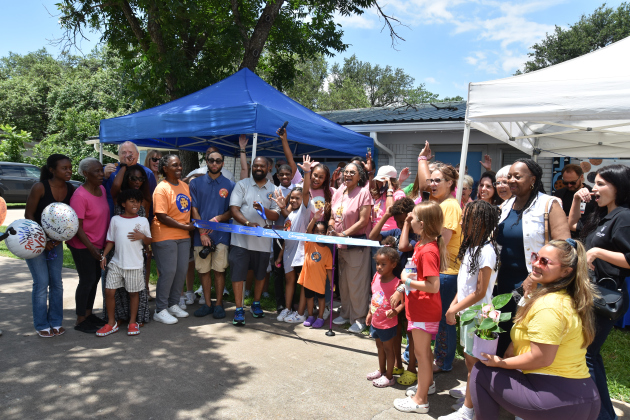 Qudduws Ware, holding scissors, and Sarah Davis, are joined by their three children to cut the ribbon on Crisp &amp; Chew, their cookie business during a chamber of commerce ceremony. Photos by Alyssa Perera