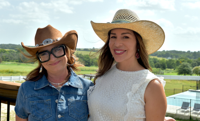 From left, Criss Parker, executive director of The Stables at Georgetown, and owner Vanessa Johnson stand on a balcony that overlooks the property in Walburg. (Photo by Kaitlyn Wilkes)