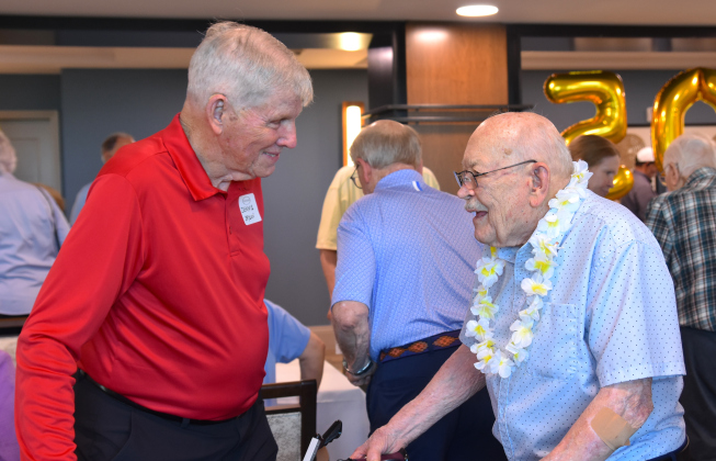 Dennis Bryson, left, a former Sun City neighbor of birthday boy Grover Trytten, right, catch up at Mr. Trytten’s birthday party that took place on July 22.