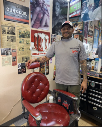 Nik Shanklin, owner of Papa Frank’s Barbershop, standing in his new booth in Premium Blend Studio, 612 East University Avenue Suite 2. Photo by Abbey Archer
