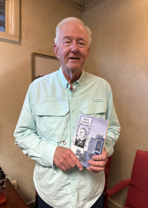 Dale Illig a copy of Yancy Lawyer, the novel he finished and published for his father Carl Illig. Photo by Abbey Archer 