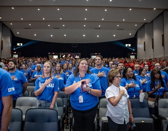 Georgetown ISD teachers and staff members stand for the Presentation of the Colors during  the Georgetown ISD Convocation on Monday, August 10, 2026.  Trustees say the tax rate election is necessary because there are no funds available in this year’s budget for employee pay raises. Photo by Andy Sharp