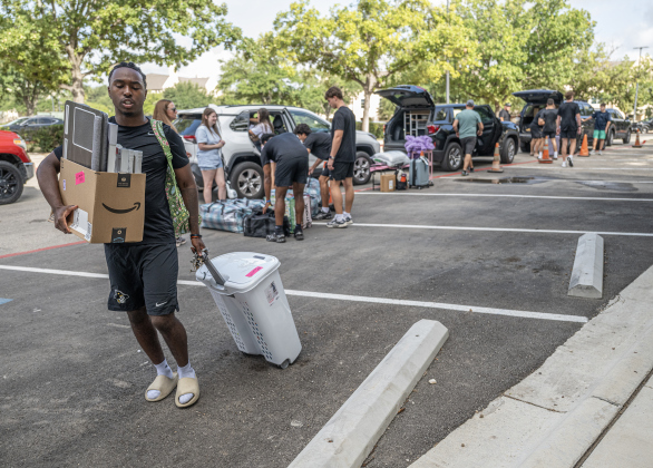 Joshua Hopkins, a freshman member of the football team  from John’s Creek, Georgia, helps other freshmen students move  into Jessie Daniel Ames Hall during freshmen move-in day at Southwestern University on Saturday, August 15, 2026.  Members of the Southwestern football team were on hand to help.