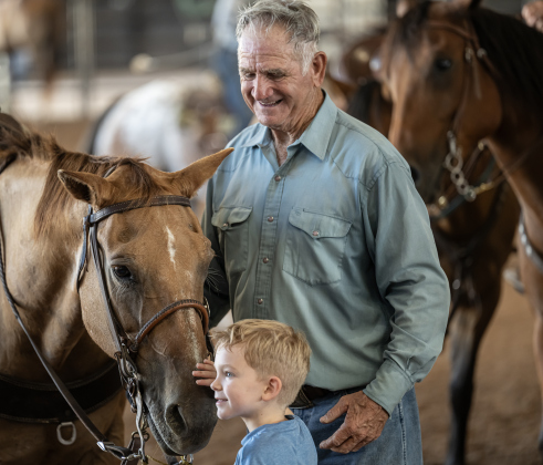 Ed Denison of Hockley, Texas, who will be 80 in October, introduces his horse called Hombre to his 8-year-old grandson Levi Bentley  during the Texas Senior Pro Rodeo Association’s Rodeo held Sunday, August 16, 2026  at the Williamson County Expo Center.