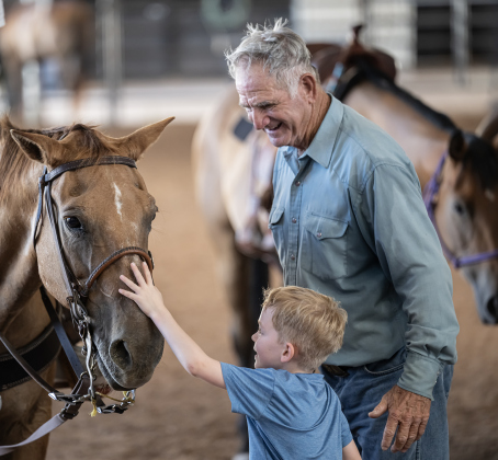 Ed Denison of Hockley, Texas, who will be 80 in October, introduces his horse called Hombre to his 8-year-old grandson Levi Bentley  during the Texas Senior Pro Rodeo Association’s Rodeo held Sunday, August 16, 2026  at the Williamson County Expo Center.
